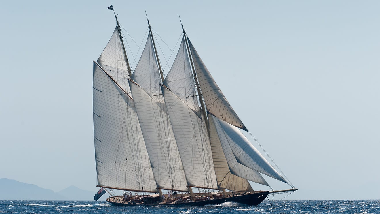 A classic luxury yachts for sale glides through open waters, embodying the charm of a rich history.
