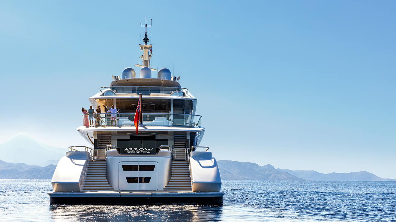 A group of friends on Arrow's deck, enjoying a luxury yacht charter and taking in breathtaking ocean views.