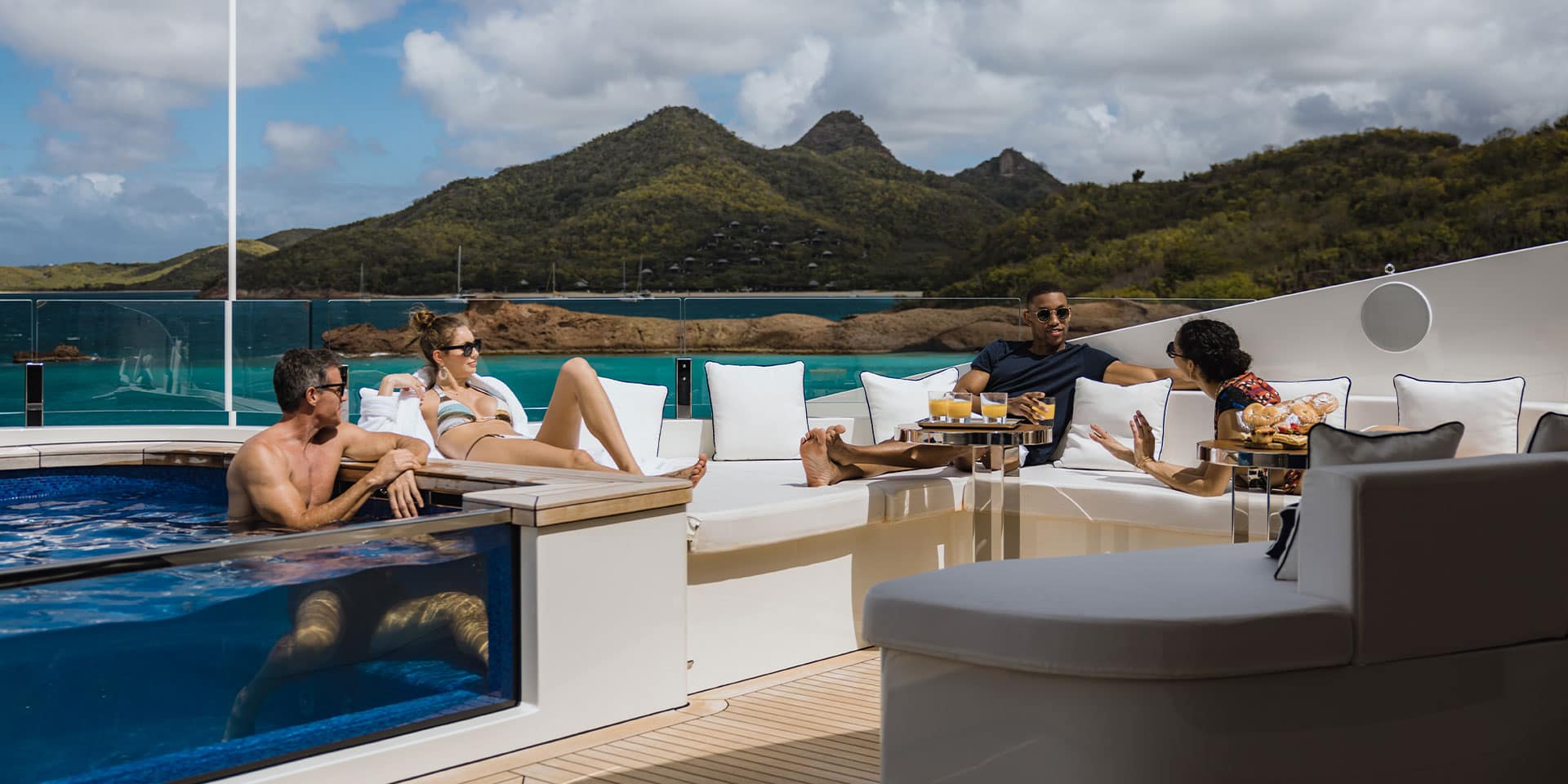 Guests relax on the yacht deck and private pool, with exceptional service from top luxury superyacht brokers.