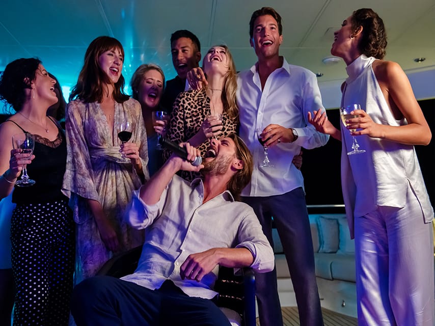 A group of friends celebrating on their Abu Dhabi private yacht charter for the Abu Dhabi Grand Prix 2024.