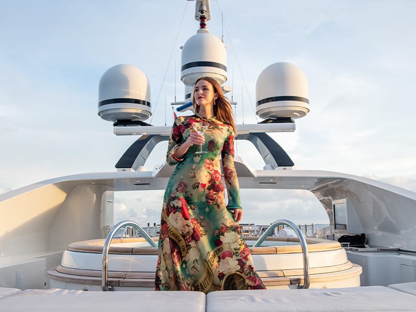 A woman surveying the view from her exclusive Formula 1 Abu Dhabi yacht charter, ready to embark on a luxurious experience at the Grand Prix.