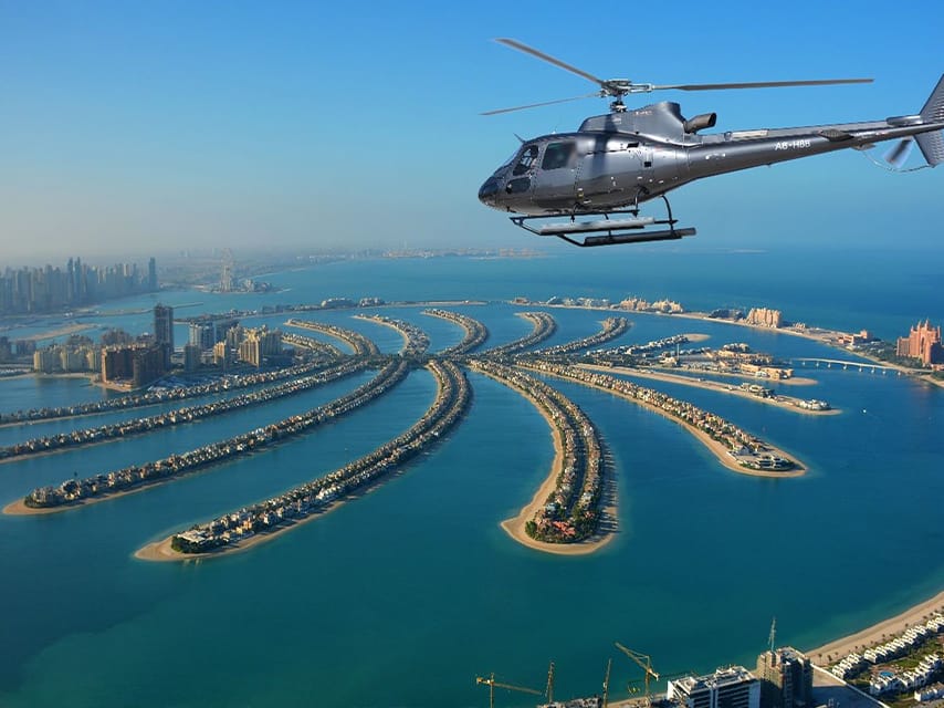 A helicopter flies over Dubai's Palm Jumeirah, giving Dubai Boat Show VIPs an unforgettable aerial view.