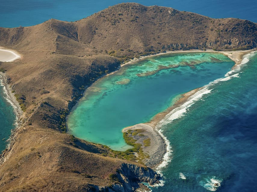 An aerial view of British Virgin Islands shows beautiful reefs to explore during a Caribbean sailing adventure.