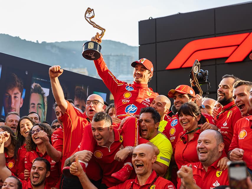 The winning team of the Monaco Grand Prix, one of the top luxury events of 2025, celebrates with their trophy.