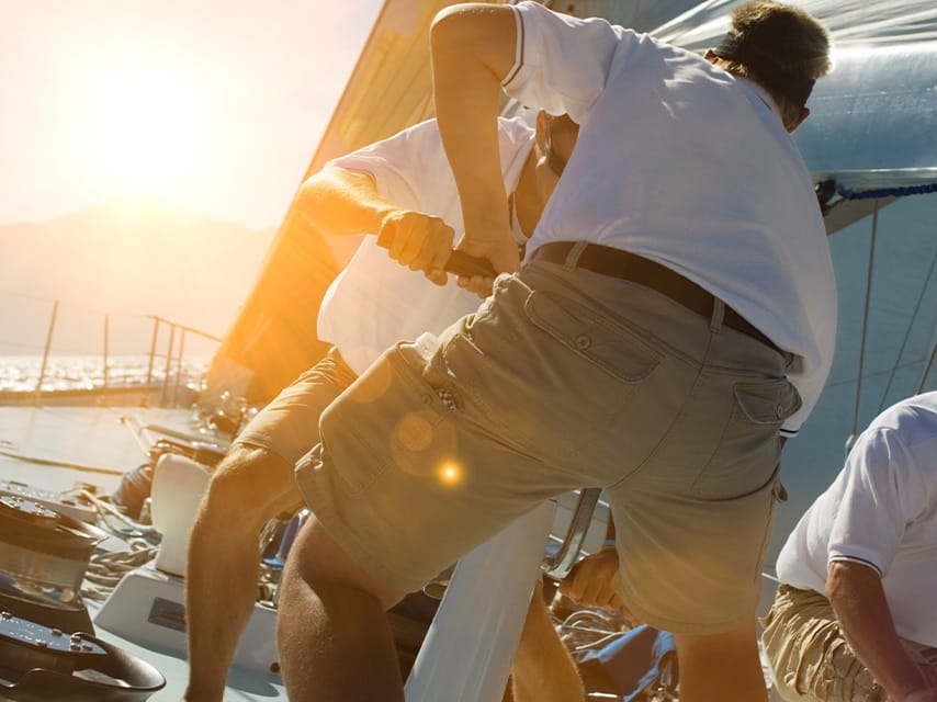 Crew members adjust the sails, working hard to stay ahead in the thrilling Bucket Regatta, St Barths premium sailing race.