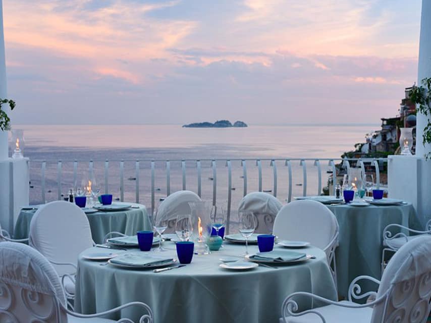 Experience seaside dining at La Sponda’s outdoor terrace, a highlight among famous restaurants in Europe.