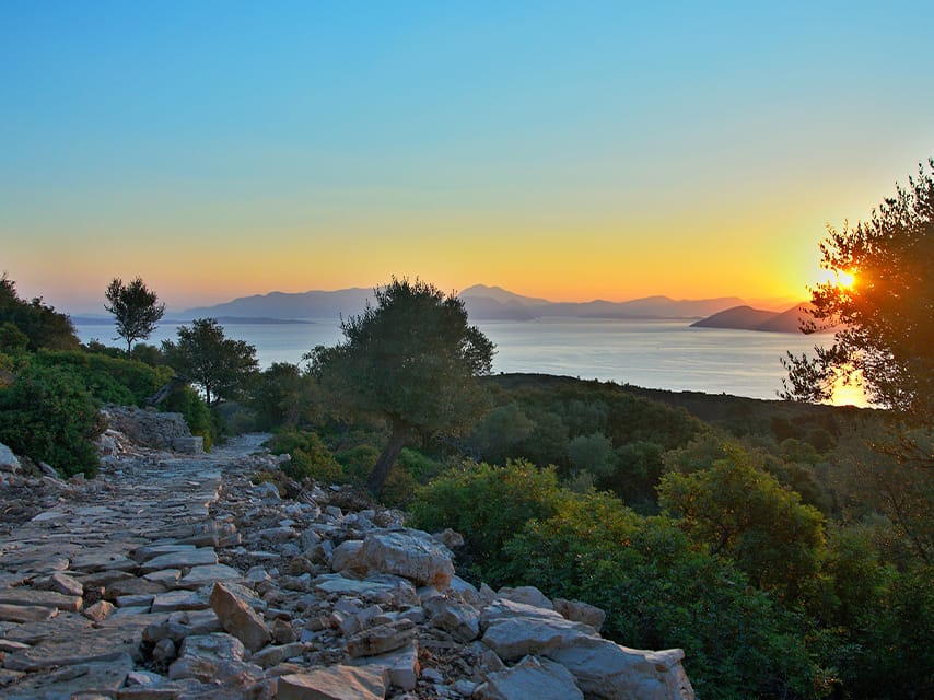 Serene sunset over turquoise waters, perfect for private relaxation during one of our luxury escapes, Corfu island experience.