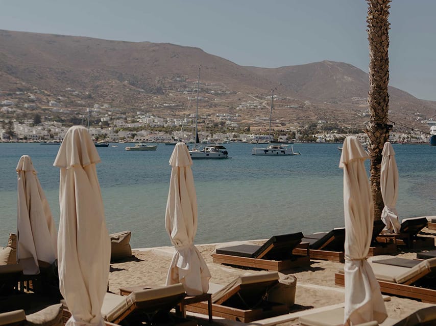 Beach loungers at Cabana Beach Bar, Paros offer an elegant setting to experience Mediterranean glamour during a yacht charter in Greece.