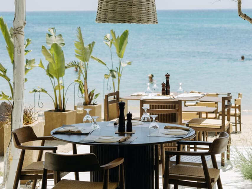 An intimate dining corner at Santana Beach Bar, Naxos offers beachside dining for a relaxed vibe during a luxury yacht charter in the Greek Islands.