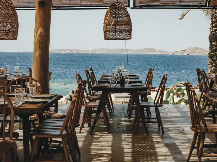 The seating at Scorpios Mykonos offers a boho-chic vibe, global music and serene beach views, a wonderful stop on a yacht charter in Greece.