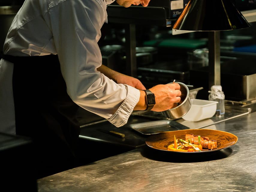 A chef prepares traditional Istria food during a private Croatian cooking class aboard a luxury yacht.