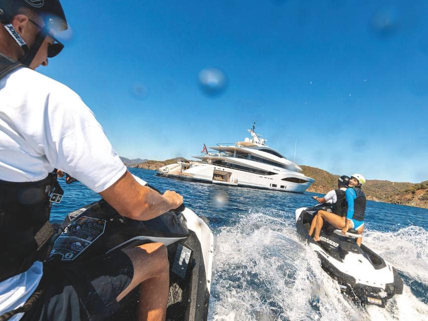Jet skiing adventures near a superyacht, the best way to island hop in Greece is a luxury yacht charter.