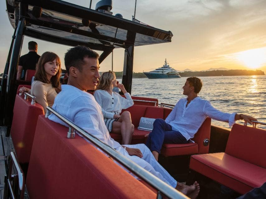 Guests step onto a tender from SUNRAYS yacht, headed for an elegant Ibiza yacht charter dinner ashore.