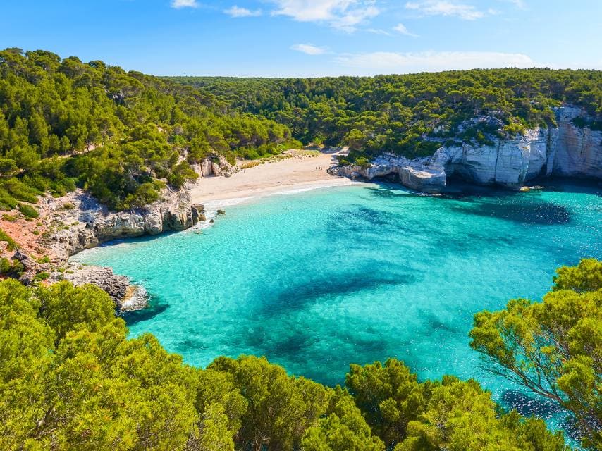 Tranquil bay views from your Menorca yacht charter are perfect for unwinding in secluded paradise.