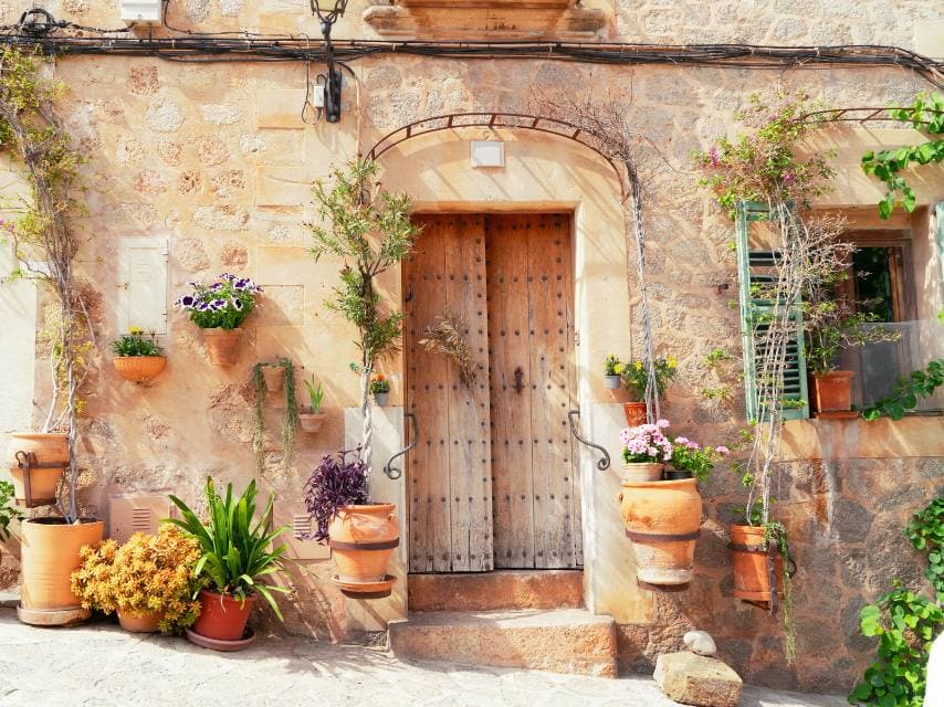 A rustic restaurant entrance in Deià, a charming village stop on your superyacht charter Balearics adventure.