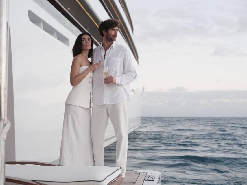 Couple enjoys post-wedding privacy on the lower deck on their luxury yacht honeymoon.