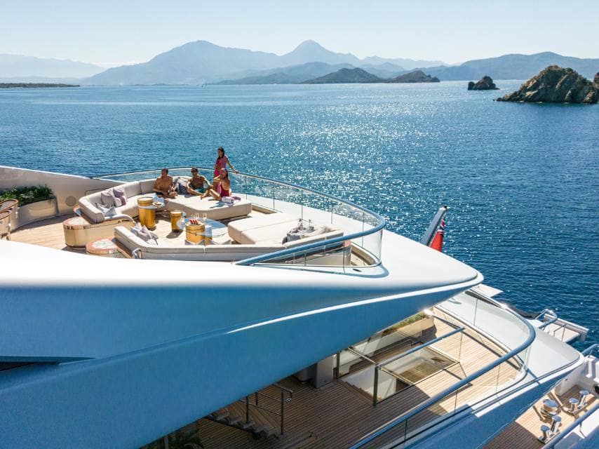 Friends gather on ARROW yacht's sundeck, living the dream of luxury holidays and honeymoons on open waters.