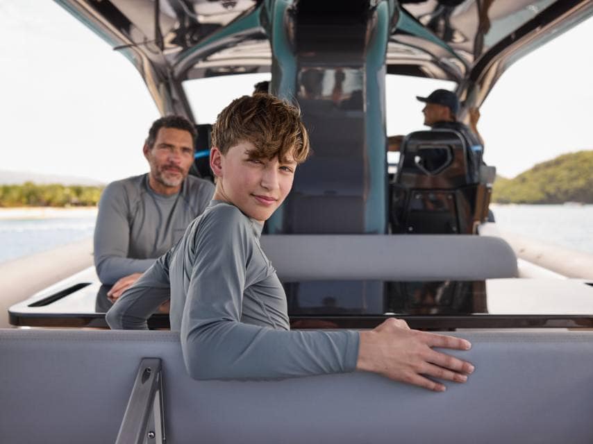 Family moment as dad and son prepare for dolphin watching on an Algarve luxury yacht charter