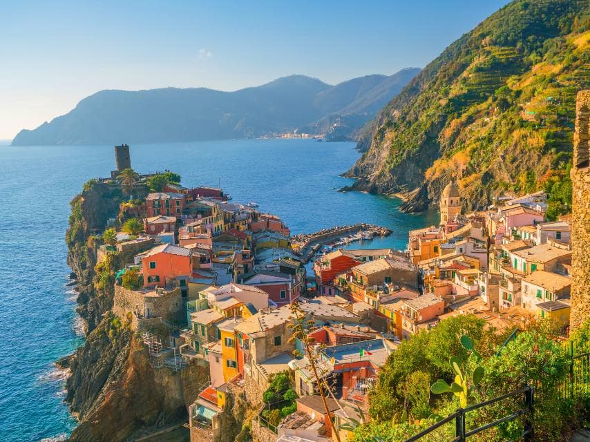 Colorful Cinque Terre villages invite exploration during a couple’s journey of getting married on a yacht.