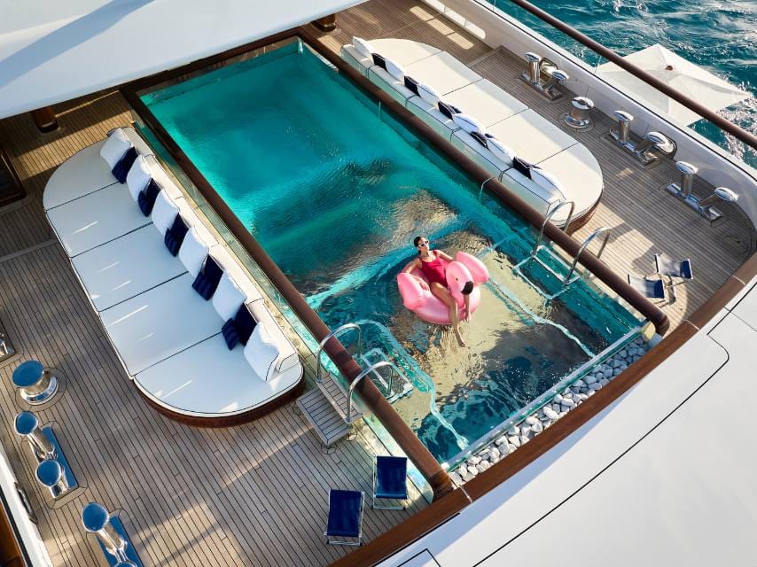 SOPHIA glass bottom pool with lady sunbathing on pool float