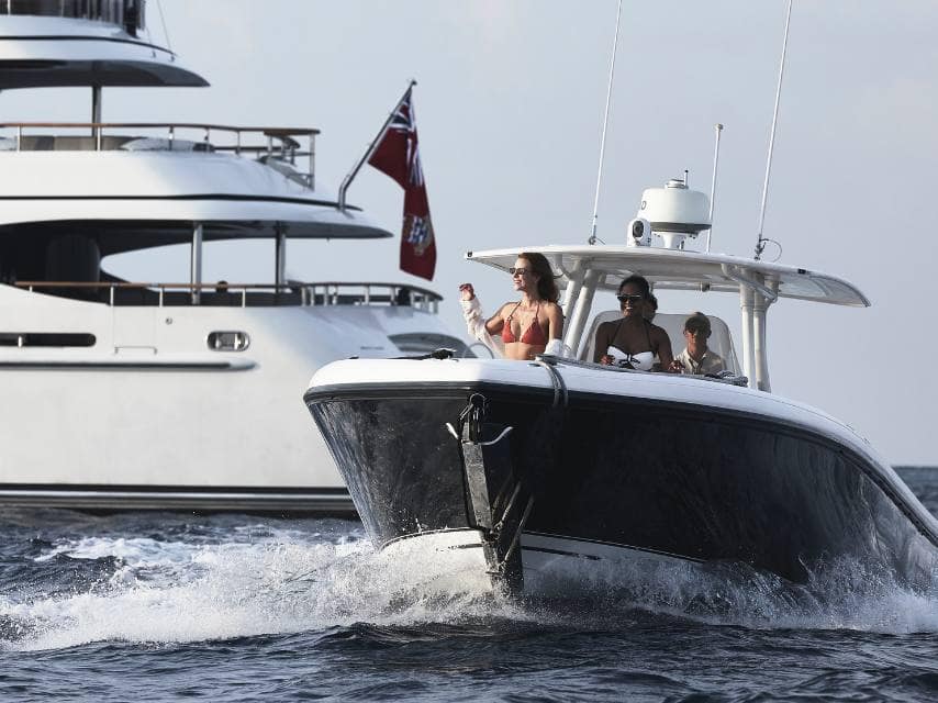 Friends arrive by tender in Rhodes, ready to explore classic Greek mythology during their yacht vacation in Greece.