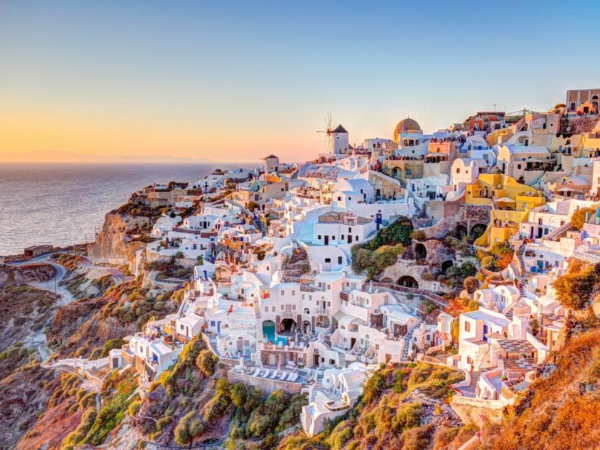 Santorini’s breathtaking sunset and white houses are highlights of any yacht vacation in Greece.