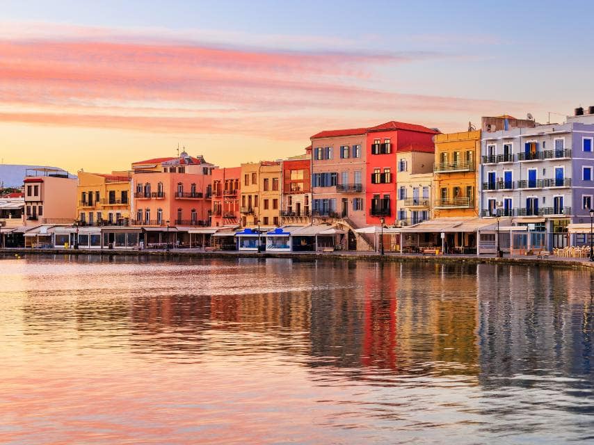 Colorful coastal homes in Chania, Crete, offer the perfect spot to relax during your Greek island luxury yacht charter.