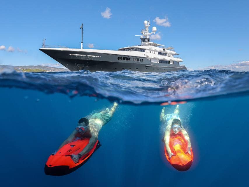 A couple use seabobs to dive beneath the surface during their luxury Mediterranean superyacht charter escape.
