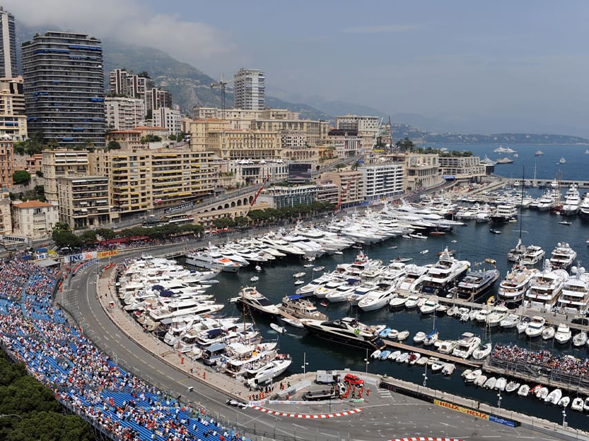 Super yachts in Monaco docked at Port Hercule for the Monaco Grand Prix, the ultimate luxury motorsport experience.