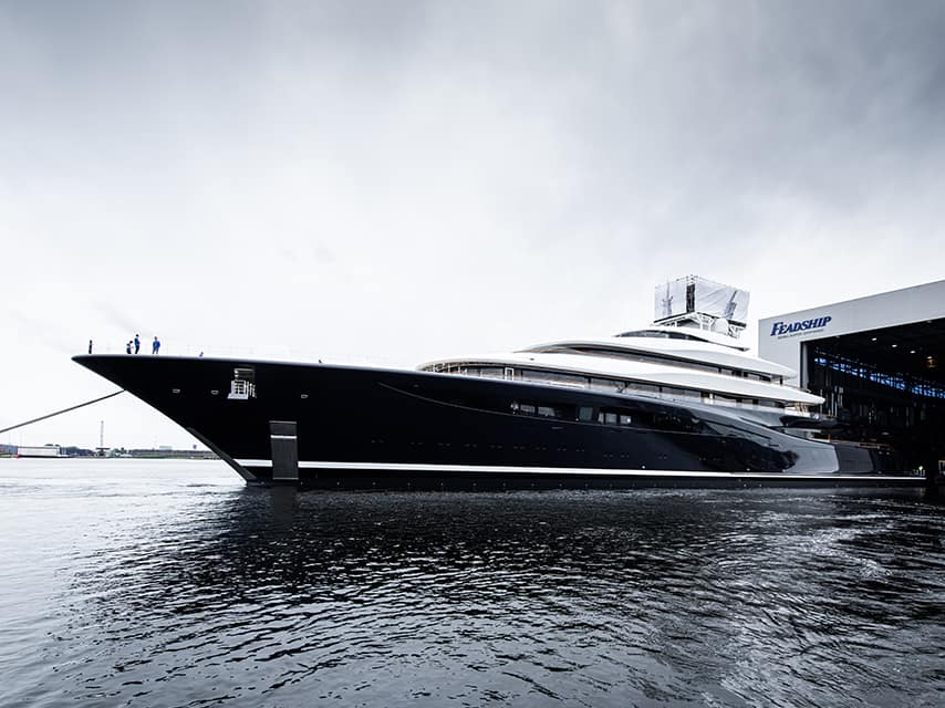 Feadship 821 for sale, a luxurious yacht, majestically docked at Feadship Van Lent shipyard.