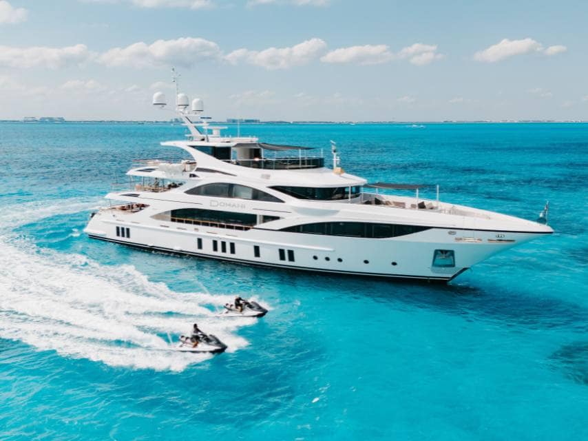 Domani Yacht running shot with jet skis