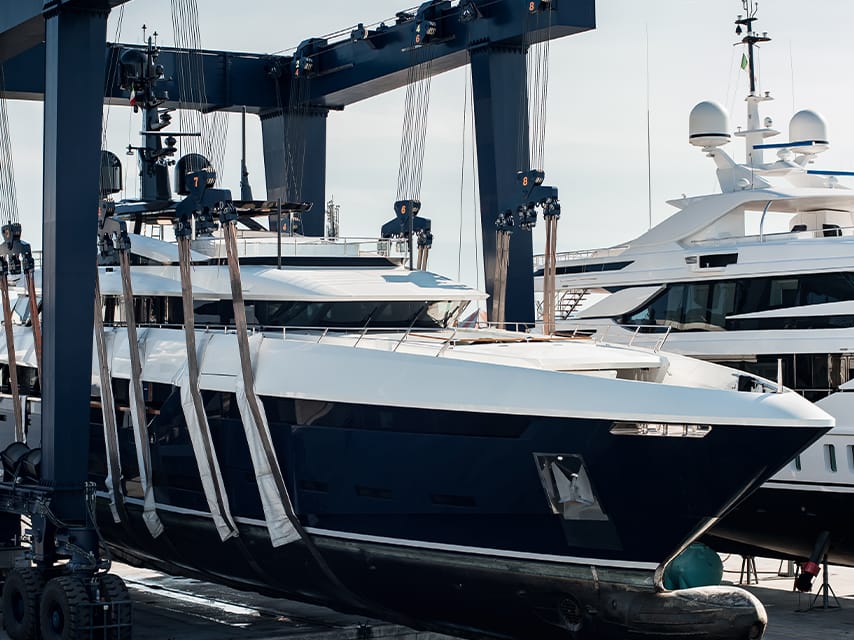 A superyacht is hauled-out at a shipyard, for routine maintenance, an essential part of the cost of maintaining a yacht.