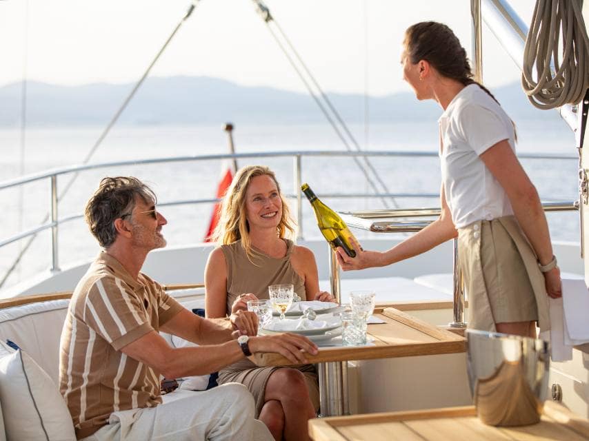 Crew serving drinks on board