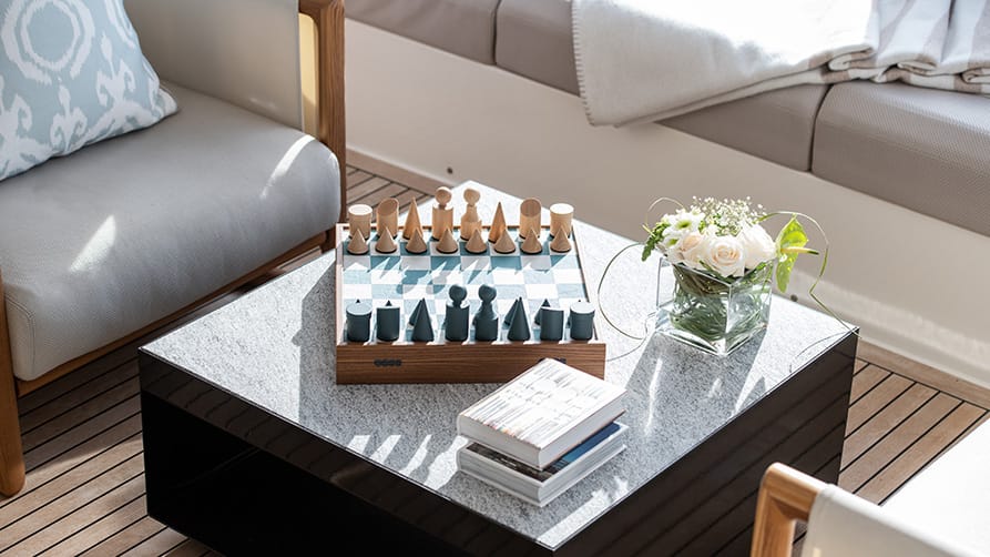 A chess game on display aboard a mega yachts for sale, highlighting the yacht's luxurious lifestyle.