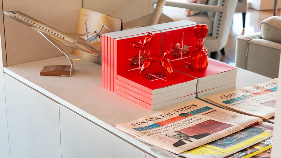 Amenities at the heliport london, featuring aviation models and select newspapers, capturing the essence of luxury travel.