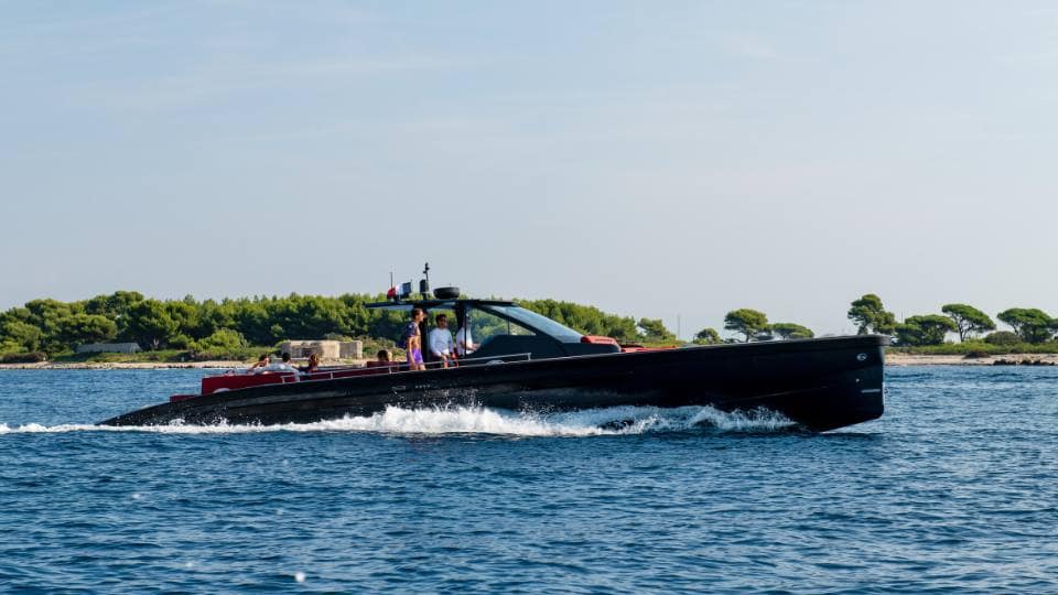 Friends travel by luxury tender from a yacht charter in Sardinia, ready to explore Costa Smeralda.