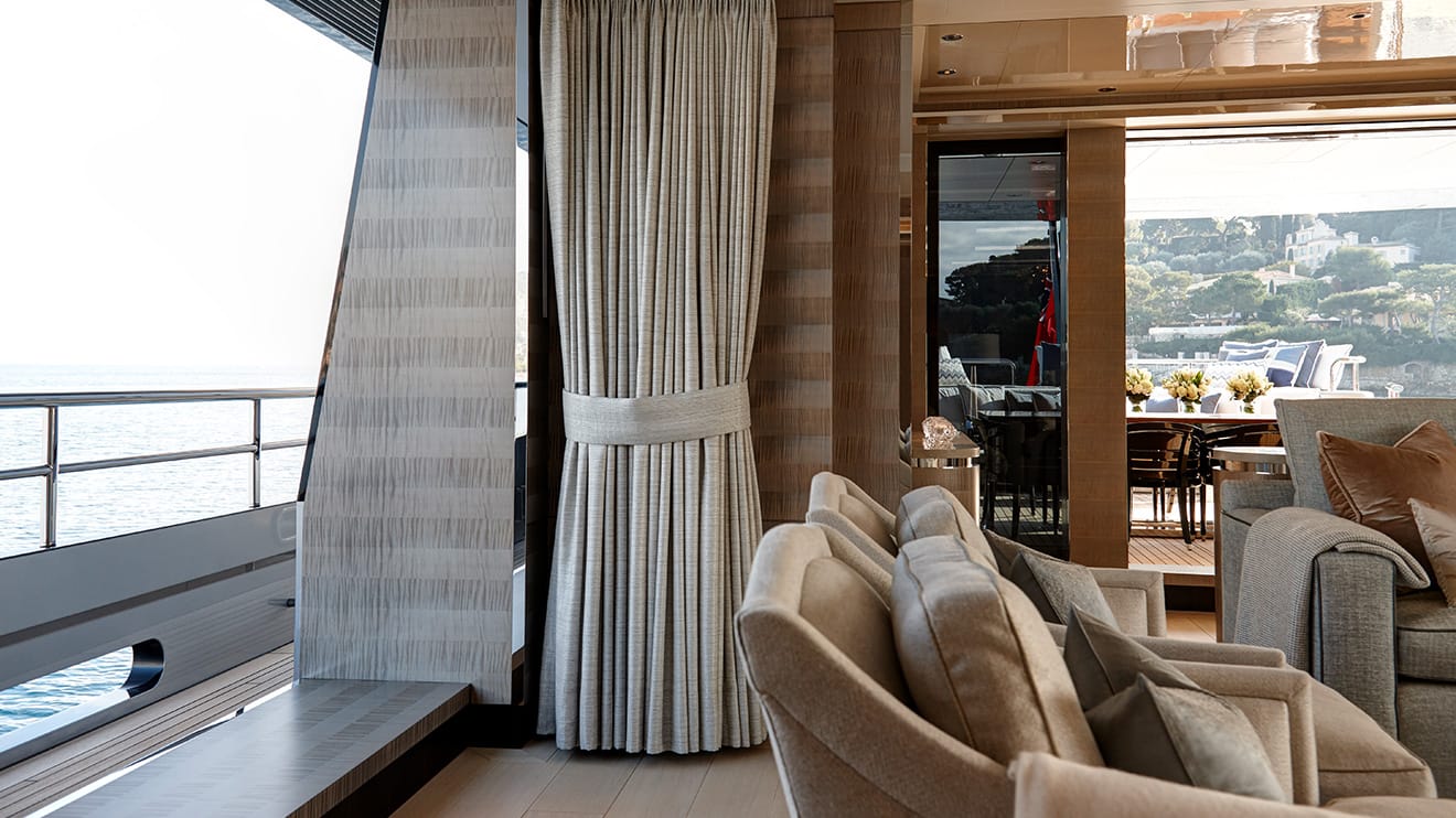 Build a yacht with an exquisite interior, showcasing elegant seating and a refined dining area.