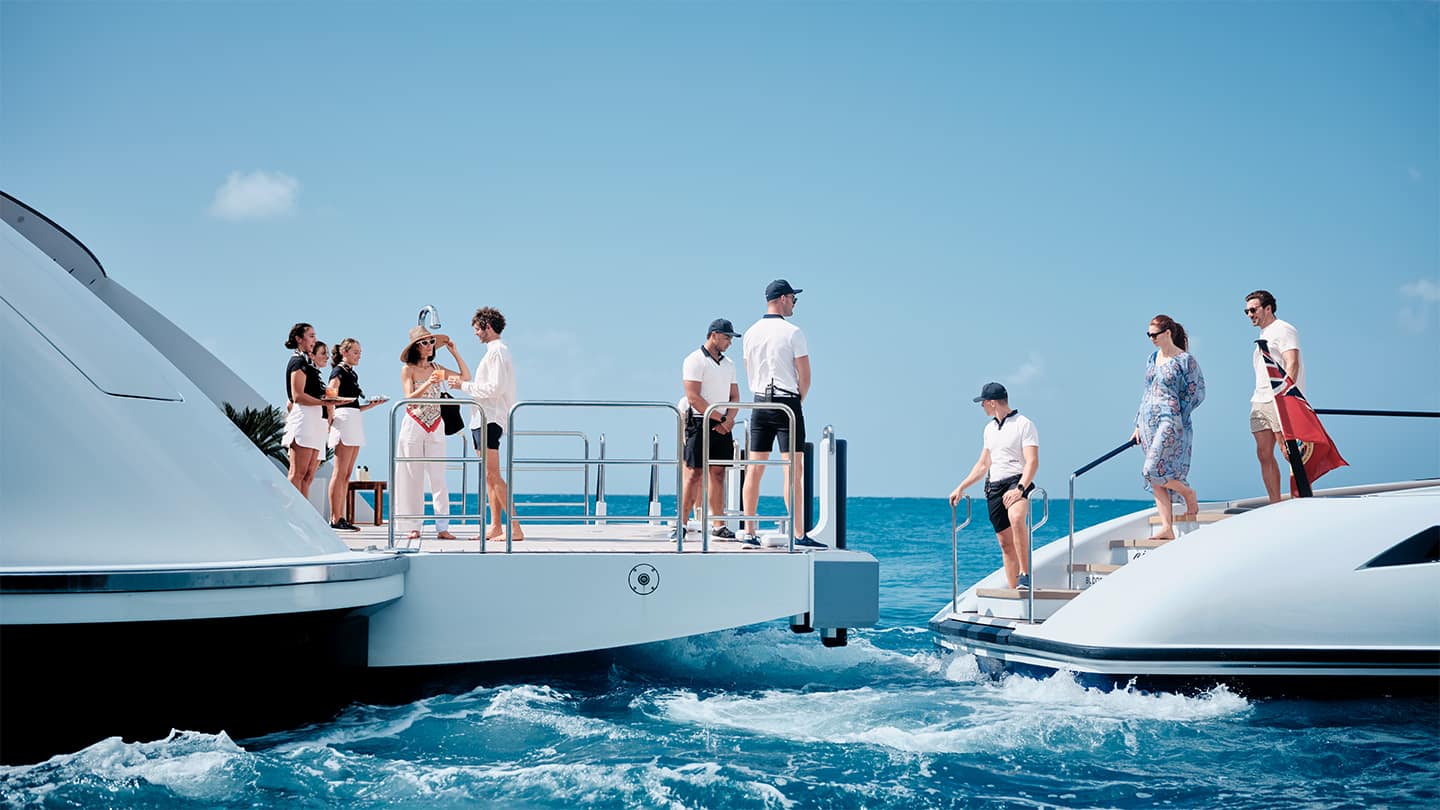 family getting from a tender onto their own superyacht