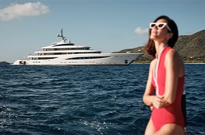 women in front of Superyacht in the Med