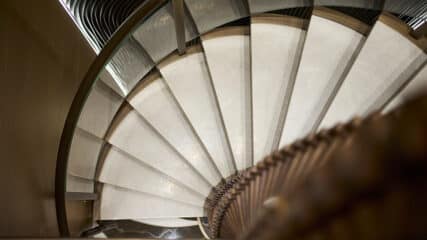 A stunning spiral staircase aboard a private yacht, styled to perfection for yacht valuation and sale.