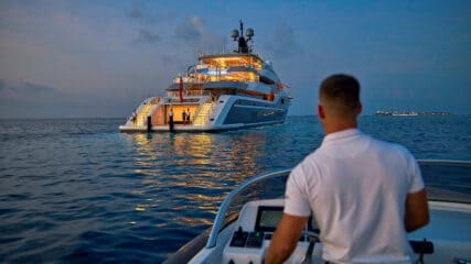 Mega yacht brokers arriving by boat to manage everything needed to sell your yacht.