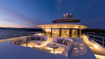 An elegant sunset view of a yacht deck, set up for luxury yacht sales