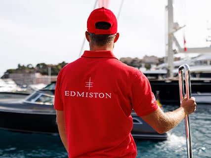 Edmiston staff awaits at the marina, offering a luxury experience guided by yacht broker Bond.