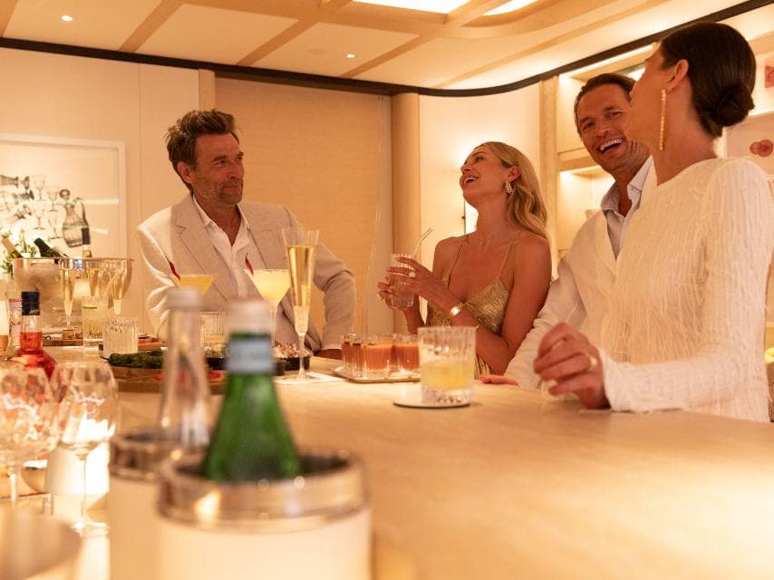 Guest enjoying a crafted cocktail onboard Miami charter yachts before heading to Art Basel.