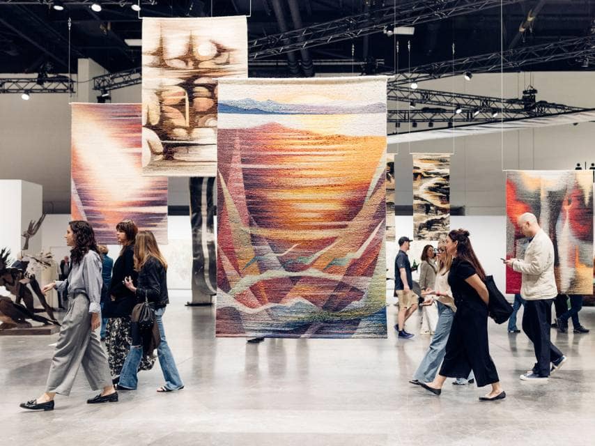 Guests exploring curated installations at an Art Basel art show, immersed in the bold creativity shaping Miami’s art scene.