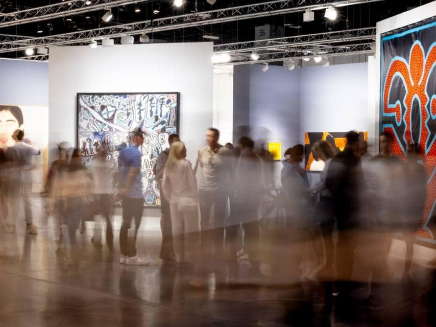 Edmiston VIP Art Basel Miami yacht charter guests in an immersive moment at an Art Basel Art show, blending culture with refined luxury.