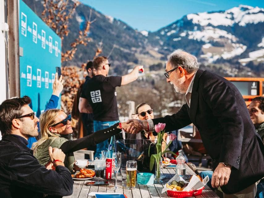 Superyacht event attendees savor lunch in the Alps, combining skiing fun with luxury networking.