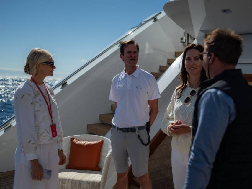 Edmiston Miami yacht brokers guide visitors through a private luxury yacht exhibition in Miami.