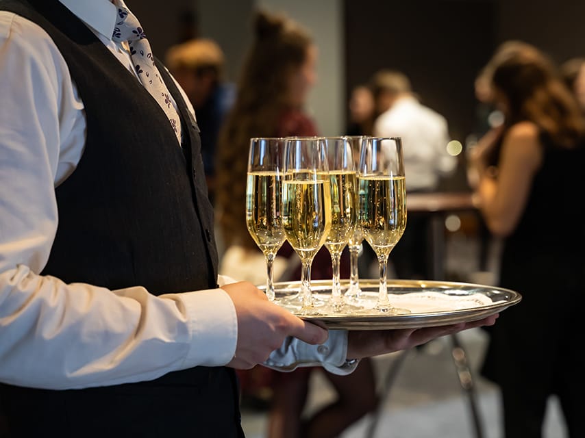 A host offers champagne to Edmiston clients at an exclusive event as part of the Palm Beach Yacht Show 2025.