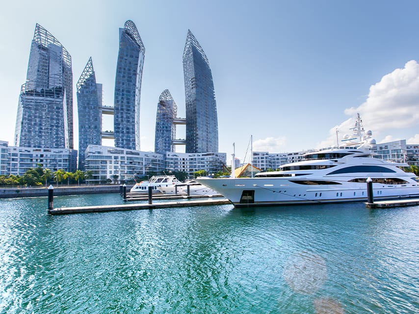 Two yachts are docked at Marina Sentosa Cove, the perfect spot to embark on a superyacht charter, Singapore experience.